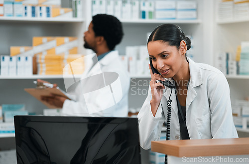 Image of Pharmacist, woman and phone call for customer support, medicine stock and inventory communication or retail service. Medical worker or doctor on telephone and computer for pharmacy or healthcare FAQ