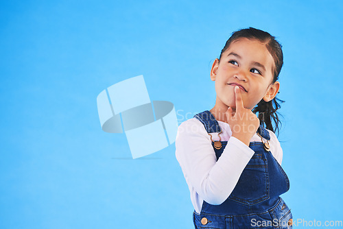 Image of Thinking, child and girl with ideas, decision and choice on a blue studio background. Mockup space, kid and model with doubt, planning and inspiration with problem solving, question and opportunity