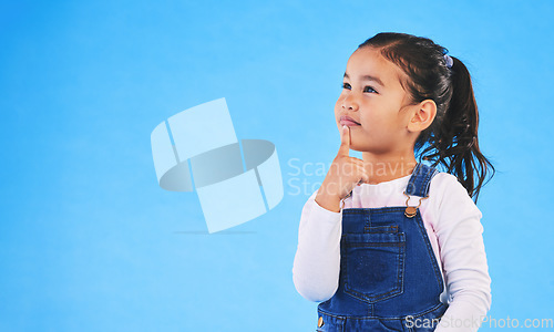 Image of Thinking, child and girl with ideas, solution and question with doubt on a blue studio background. Mockup space, kid or model with planning, choice and inspiration with problem solving or opportunity