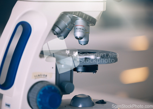 Image of Microscope, lab and science research with technology testing for a pharmaceutical or medical study. Chemistry, biometric and molecule analytics equipment for particles and dna process in a hospital