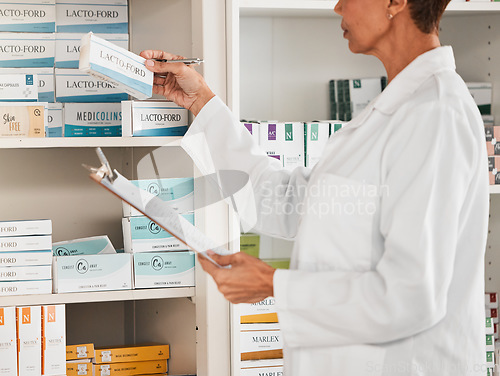 Image of Woman, pharmacist and inventory inspection on pills, tablets or medication on shelf at the pharmacy. Female person, medical or healthcare worker checking stock or pharmaceutical products at drugstore