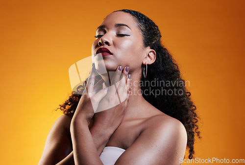 Image of Beauty, makeup and curly hair with face of woman in studio for texture, fashion and cosmetics. Self care, salon and hairstyle with model on orange background for skincare, spa treatment and mockup