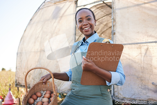 Image of Portrait, farm and black woman with clipboard and chicken eggs for sustainability, agriculture and supply chain in countryside. Face, smile and farmer with checklist or poultry, produce or management