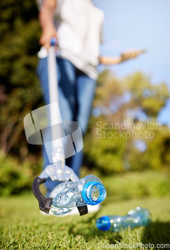 Image of Park, pollution and closeup for cleaning, plastic bottle and and tools for climate change in nature. Person, garbage or trash on grass with help for environment, forest or earth with sustainability