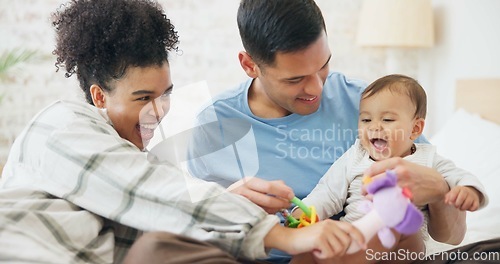 Image of Family, couple and quality time with baby, mom and dad playing with toys for fun, laughing together in home, bedroom or nursery. Newborn, infant and happiness in motherhood, family or child smile