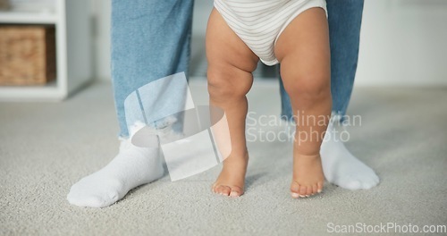 Image of Legs, baby learning to walk with parents and growth, development and early childhood with motor skills. Family, support and first steps with trust, progress and balance with milestone and feet