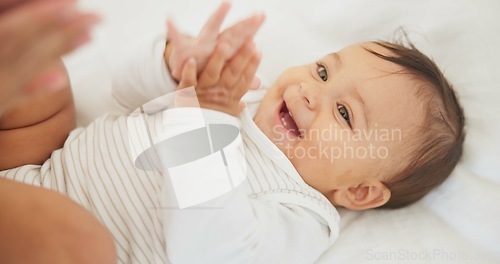 Image of Infant baby, clapping hands and bed with parent, care or learning with smile, love or childhood development. Young happy kid, nursery or bedroom with teaching, applause or excited face in family home