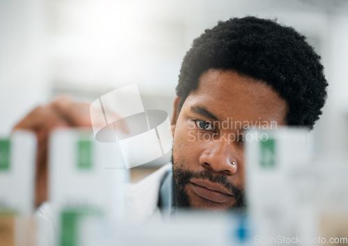 Image of Black man, pharmacist, drugs and health with medicine, prescription and organize stock in pharmacy. Pills, inventory with healthcare and African medical worker, hospital dispensary and pharmaceutical