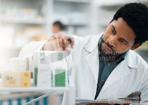 Image of Black man, pharmacist and check stock, drugs and health, prescription medicine and supplements in pharmacy. Organize inventory, healthcare and medical, hospital dispensary and pharmaceutical pills