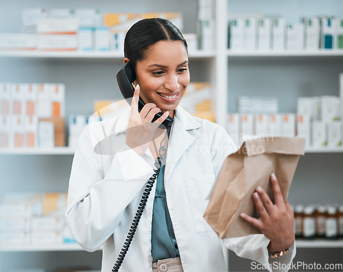 Image of Phone call, pharmacy and woman with package for medicine, prescription and medication collection. Healthcare, medical care and happy pharmacist speaking for telehealth, consultation and order service