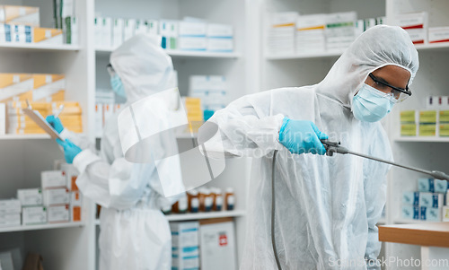 Image of Pharmacist, team and cleaning inventory with face mask in decontamination or inspection together at drugstore. People, healthcare or medical professional in pharmacy disinfection or bacteria removal