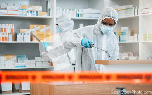 Image of Biohazard, spray and disinfect with people in a pharmacy for decontamination after a medical accident. Hazmat, chemical or cleaning with healthcare personnel in a drugstore to sanitize and isolate