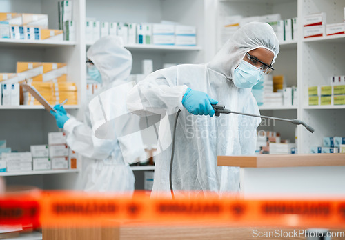 Image of Hazmat, chemical and disinfect with people in a pharmacy for decontamination after a medical accident. Biohazard, spray or cleaning with healthcare personnel in a drugstore to sanitize and isolate