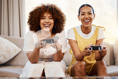 Image of Women on sofa playing video game, excited fun and relax in home living room together on internet with controller. Online gaming, esports and happy gamer friends on couch with virtual app in apartment