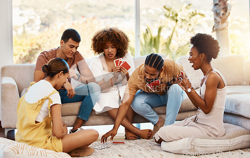 Image of Game, relax or friends playing cards, poker or black jack at home for gambling together in a holiday party. Diversity, men or group of happy women laughing in living room in a fun match competition