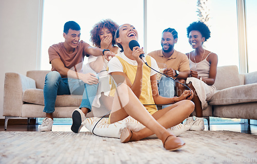 Image of Microphone, relax or friends singing in home living room together in a party on holiday vacation break. Girl singer, happy men or group of funny women laughing in a fun karaoke competition or game