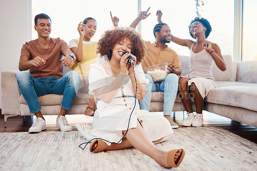 Image of Microphone, friends or happy woman singing in home living room together in party on holiday vacation break. Girl singer, men or group of funny women laughing in a fun karaoke game with popcorn snacks