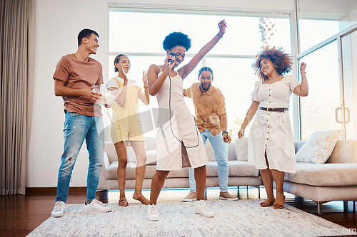 Image of Sing, energy and friends dancing in the living room with a microphone to music, playlist or radio. Happy, diversity and young people moving, bonding and having fun together with karaoke at home.