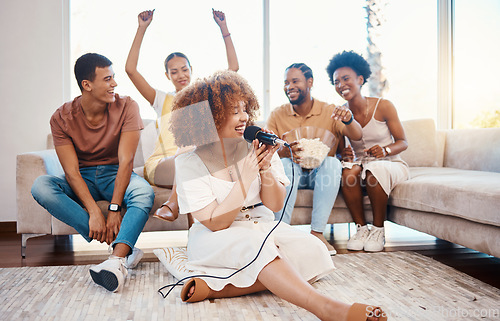 Image of Microphone, happy people or woman singing in home living room together in party on holiday vacation break. Girl singer, men or group of funny women laughing in a fun karaoke game with popcorn snacks