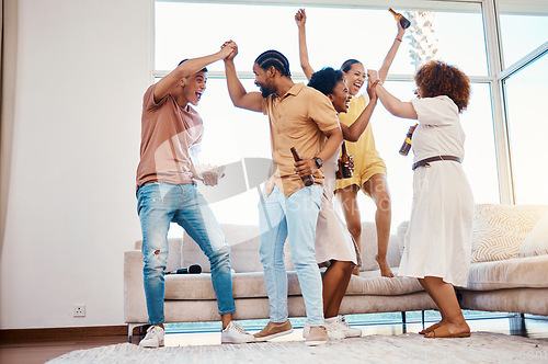 Image of Beer, excited and friends celebrate at a house with happiness, fun and energy in a lounge. Diversity, alcohol and party with men and women together for drinks, social gathering or reunion at home