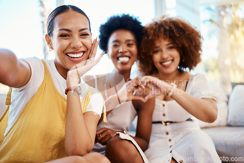 Image of Portrait, heart hands and selfie of friends in home living room, bonding and having fun on sofa. Face, profile picture and love sign of group of women in photography, happy memory and emoji for care