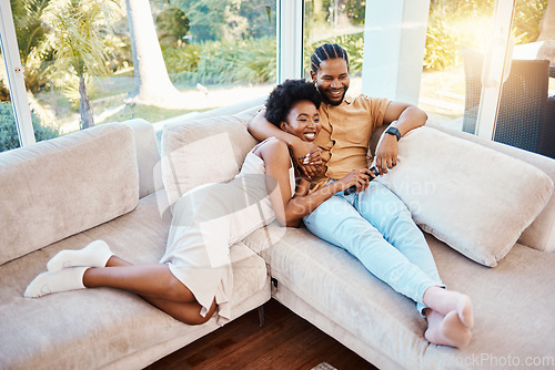 Image of Happy, above and a black couple on the sofa, watching tv and talking in a house. Smile, love and an African man and woman with care, speaking and conversation on the living room couch for a movie