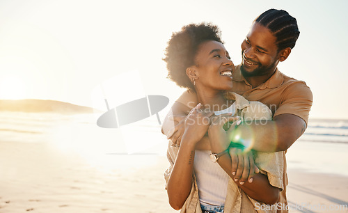 Image of Smile, hug and couple at the beach at sunset for travel, romance and relax in nature together. Love, freedom and happy man with black woman at sea embrace, connect and enjoy ocean adventure in Miami