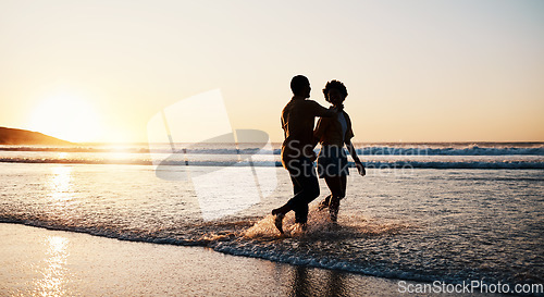 Image of Beach sunset, sea water and silhouette couple walking, connect or enjoy romantic holiday in South Africa. Love, ocean waves and dark shadow of summer people bond, talking and relax on evening journey