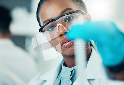 Image of Science, study and black woman with test tube in laboratory, medical engineer and results. Biotechnology, pharmaceutical and research, scientist or lab technician checking vaccine solution in glass.