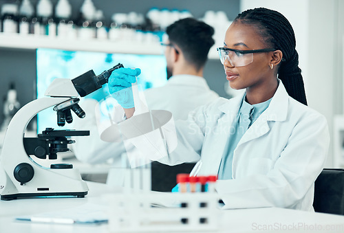 Image of Scientist, woman and microscope or blood test, research and bacteria, virus or vaccine solution in medical study. Professional doctor or science student with glass tube, biotechnology and laboratory