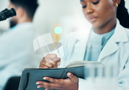 Image of Results, black woman or scientist writing research notes for analysis on experiment or medical information. Notebook, biologist or expert in a laboratory with documents info for science development