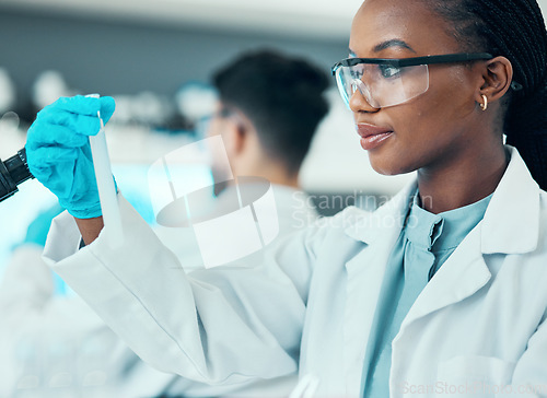 Image of Science, research and black woman with test tube in laboratory, results and medical engineer. Biotechnology, pharmaceutical study and vaccine, scientist or lab technician checking solution in glass.