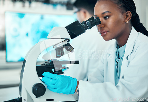 Image of Microscope, science and female scientist in a lab for medical pharmaceutical research. Professional, scientific and African woman researcher working on molecule analysis with biotechnology equipment.