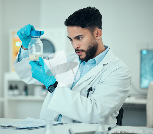 Image of Science, results and man with bottle in laboratory, research and medical engineering with soil sample. Biotechnology, botany study and nature, scientist or lab technician checking sand in glass jar.