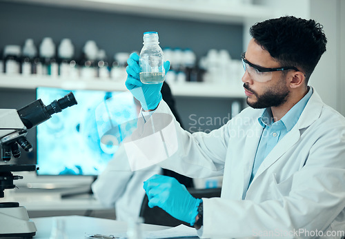 Image of Science, safety and man with bottle in laboratory, research and medical engineering with sample. Biotechnology, vaccine study and liquid, scientist or lab technician checking solution in glass jar.