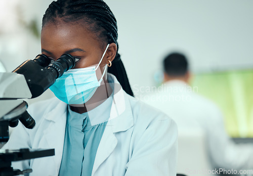 Image of Microscope, science and female scientist with a face mask in a medical pharmaceutical lab. Professional, scientific and African woman researcher working on virus research with biotechnology equipment