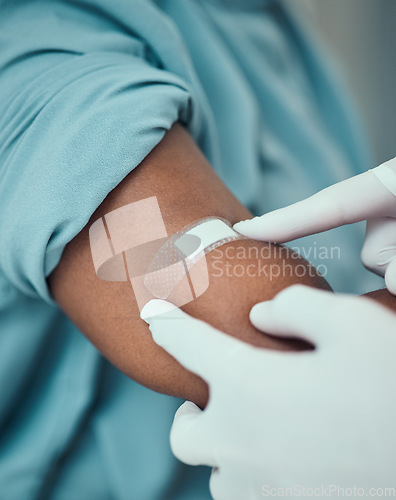 Image of Plaster, vaccine and hands of doctor with patient with bandage for flu shot, injection and immunity. Healthcare, hospital and closeup of arm of person for medicine, vaccination and virus protection