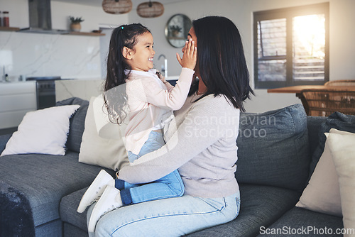 Image of Touch, happy and playful with mother and daughter on sofa for love, care and support. Funny, calm and relax with woman and young girl embrace in living room of family home for peace, cute and bonding