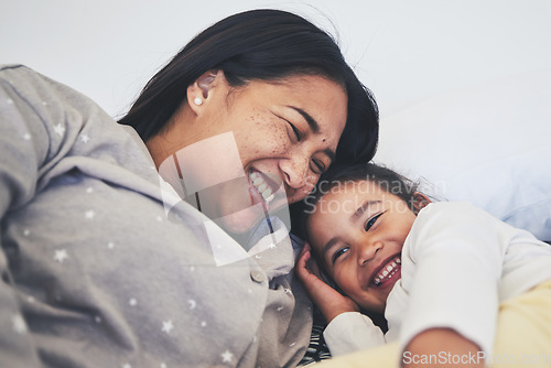 Image of Laugh, mother and daughter in bed at home with love, care and happiness in morning. A young woman and girl child together in a bedroom for fun time, playing and security or relax in a family house