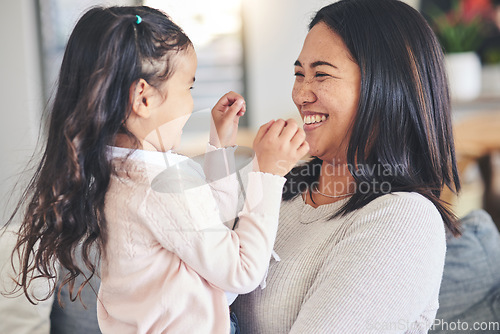 Image of Funny, happy and playful with mother and daughter on sofa for love, care and support. Smile, calm and relax with woman and young girl embrace in living room of family home for peace, cute and bonding