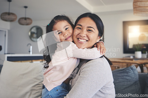 Image of Hug, happy and portrait of mother and daughter on sofa for love, care and support. Smile, calm and relax with woman and young girl embrace in living room of family home for peace, cute and bonding