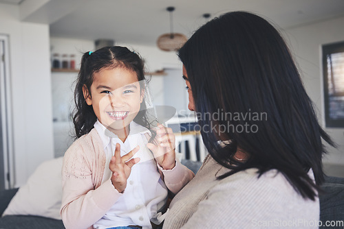 Image of Love, smile and portrait of mother and daughter on sofa for playful, care or support. Happy, calm and relax with woman and young girl embrace in living room of family home for peace, cute and bonding