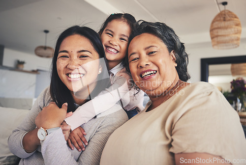 Image of Hug, women and generations with portrait of family on sofa for smile, bonding and support. Happy, relax and grandparent with mother and child in living room at home for calm, care and peace together