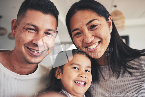 Image of Selfie, happy and portrait of a child with her parents bonding in the living room of their home. Smile, love and girl kid taking a picture with her interracial mother and father at their family house