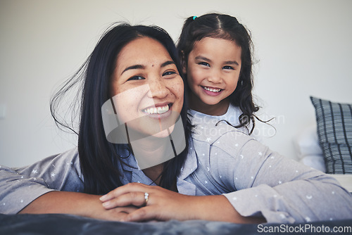 Image of Portrait, mother and daughter in bed at home with love, care and happiness in morning. A young woman and girl child together in a bedroom for fun time, playing and security or relax in a family house