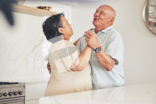 Image of Happy, holding hands or old couple dancing in home kitchen for love, care or support while bonding together. Smile, elderly man or senior woman in celebration for anniversary or romance in retirement