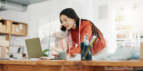 Image of Phone call, laptop and creative with a designer asian woman at work in her fashion office for a style order. Contact, ecommerce and design with a female employee talking on her phone for retail