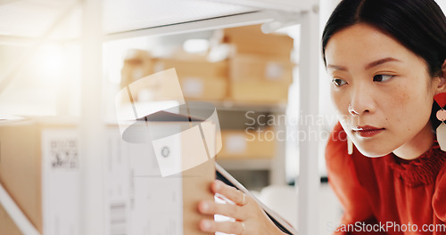 Image of Stock, planning and logistics with asian business owner doing inventory and ecommerce orders on tablet in office warehouse. Retail, management and woman factory manager writing list for shipping box