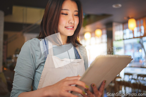 Image of Restaurant, tablet and Asian woman online for order for food service, inventory and check menu. Coffee shop, small business and happy waitress, barista or manager on digital tech for cafe website