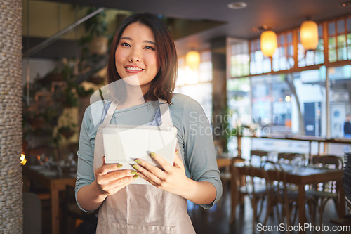 Image of Restaurant, waitress and Asian woman on tablet for order for food service, inventory and sales. Coffee shop, small business and happy person, barista or manager on digital tech for cafe website